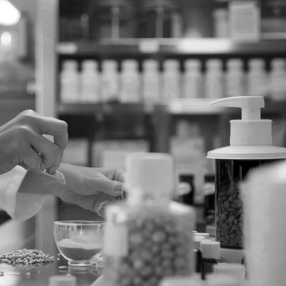 Person working with ingredients in a laboratory setting